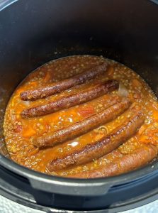 Déposer les merguez et poursuivre la cuisson