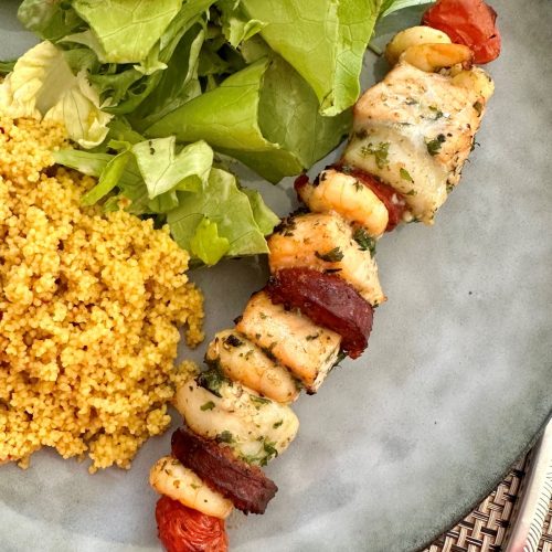 Brochette de saumon, crevettes, saint-jacques et chorizo avec couscous épicé et salade